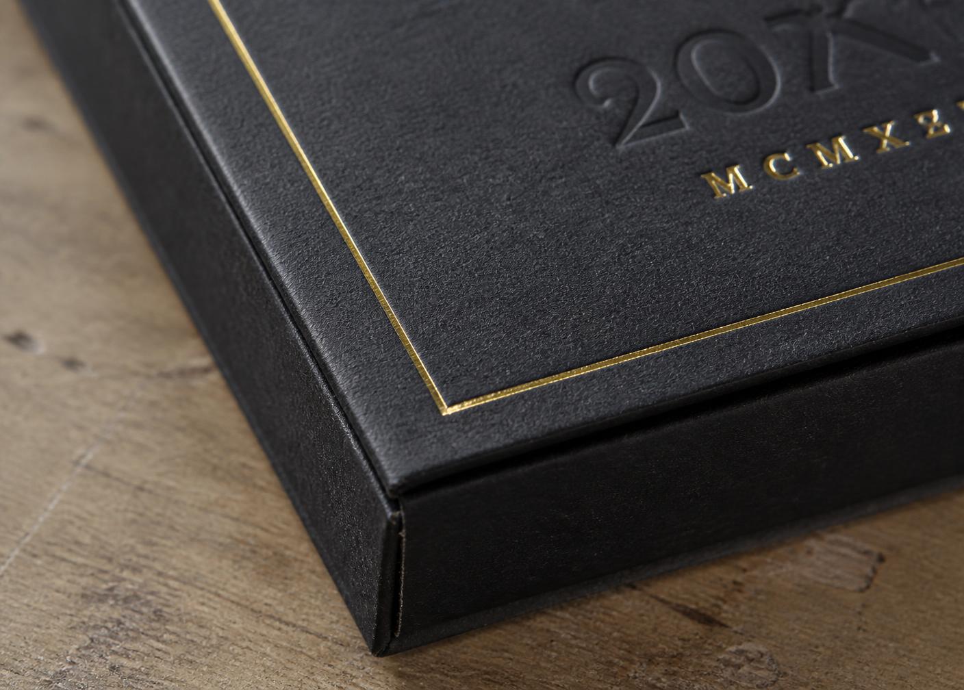Close-up of gold foil and embossing detail on a premium box